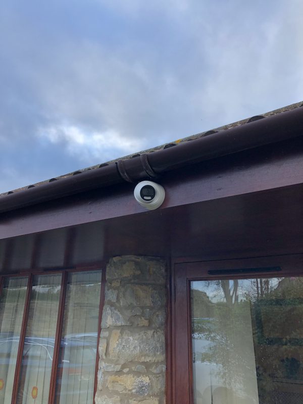 A camera on the roof of a house.